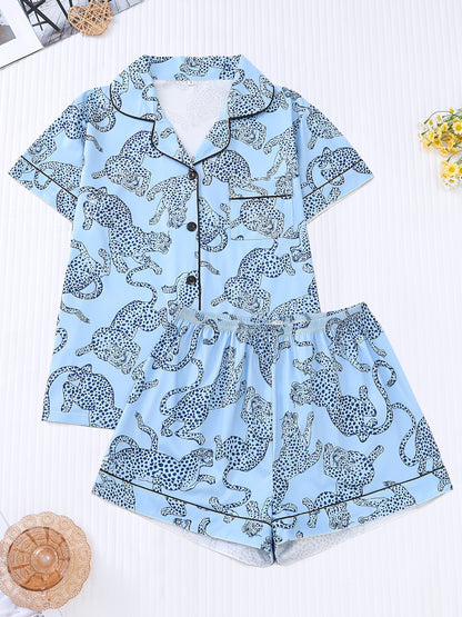 White satin-look pajama set with black cheetah print — short-sleeve button-up top with chest pocket and elastic waist shorts, 95% Polyester/5% Elastane