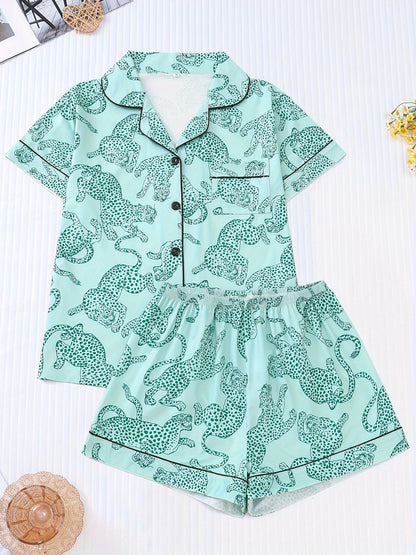 White satin-look pajama set with black cheetah print — short-sleeve button-up top with chest pocket and elastic waist shorts, 95% Polyester/5% Elastane