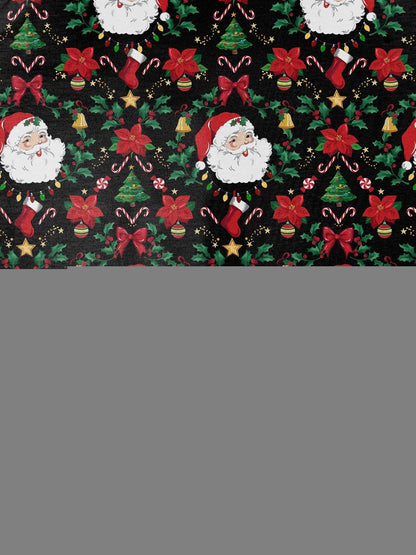 Woman wearing black short-sleeve pajama set with Santa, poinsettia and candy cane print — button-up top and elastic waist shorts with red piping