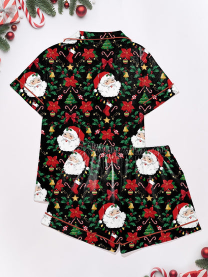 Woman wearing black short-sleeve pajama set with Santa, poinsettia and candy cane print — button-up top and elastic waist shorts with red piping