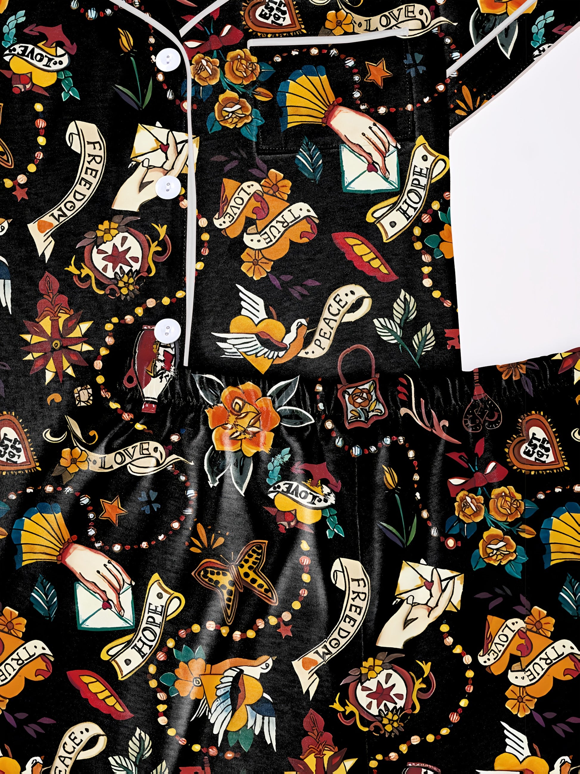 Navy/black modal pajama set with vintage tattoo‑style roses, doves and script banners — short‑sleeve button top and elastic waist shorts with piping