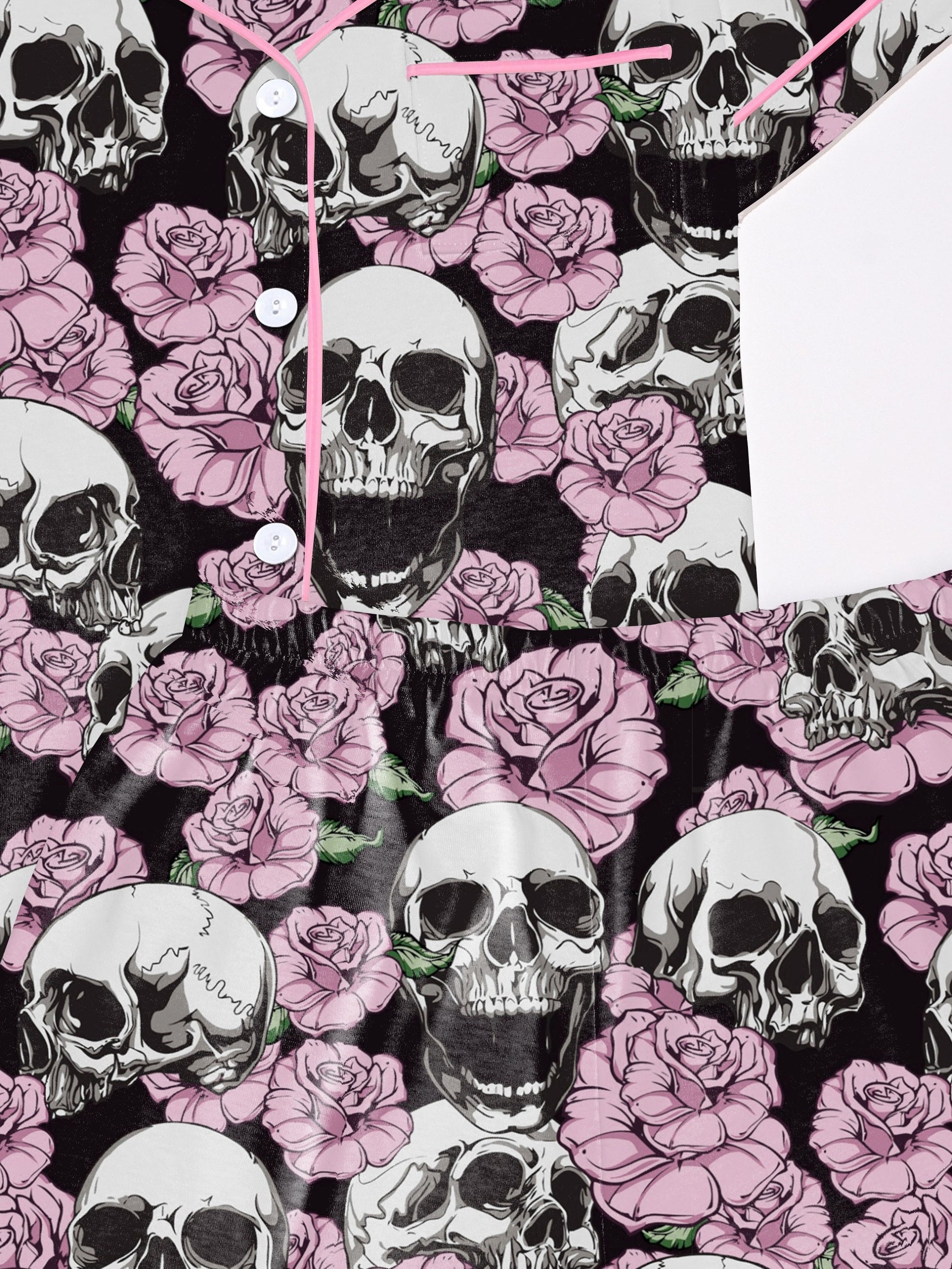Black modal pajama set with white skulls and pink roses — short‑sleeve button top and elastic waist shorts with pale contrast piping
