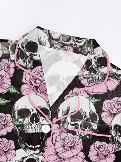 Black modal pajama set with white skulls and pink roses — short‑sleeve button top and elastic waist shorts with pale contrast piping