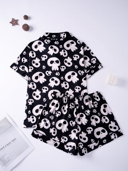 Black modal pajama set with cream skull motifs — short‑sleeve button top and elastic waist shorts with piping