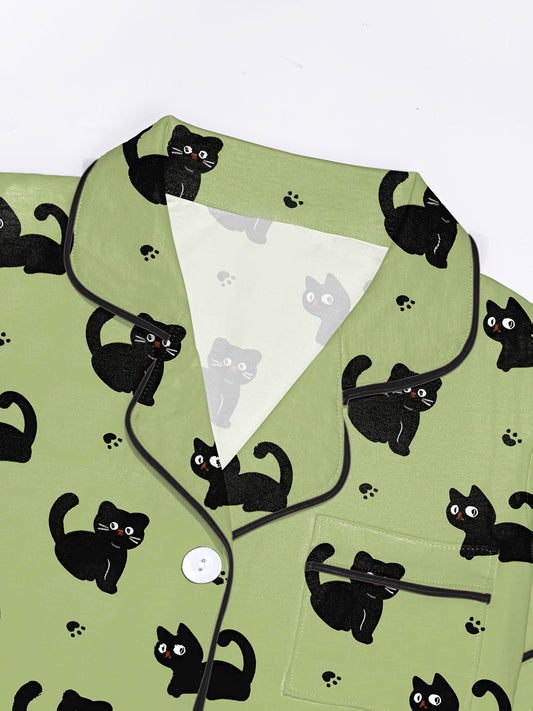 Pistachio silk‑touch modal short‑sleeve pajama set with black cat doodle print — button top with notch collar and elastic waist shorts with black piping