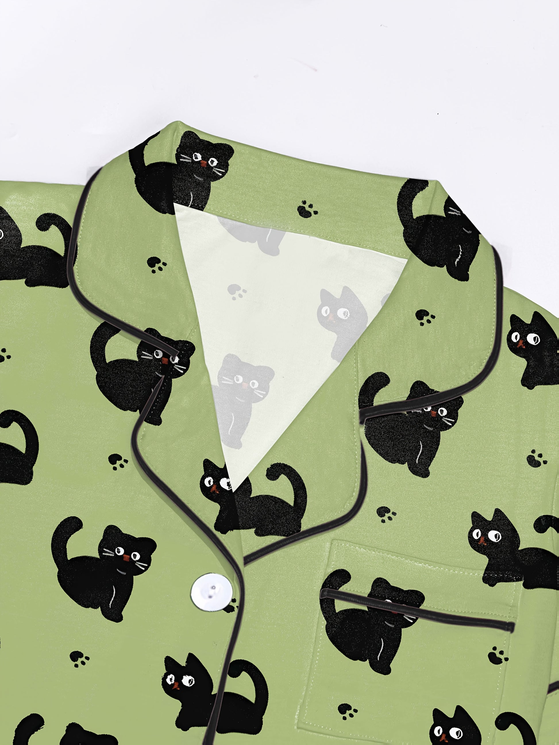 Pistachio silk‑touch modal short‑sleeve pajama set with black cat doodle print — button top with notch collar and elastic waist shorts with black piping