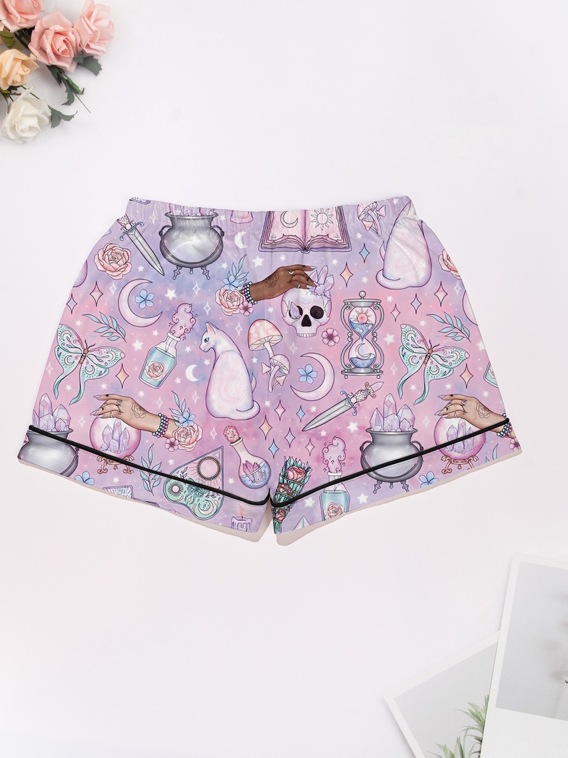 Lavender short-sleeve women’s pajama set with tarot, crystals, crescent moons and cat motifs — button-up top and elastic waist shorts in 95% polyester 5% elastane