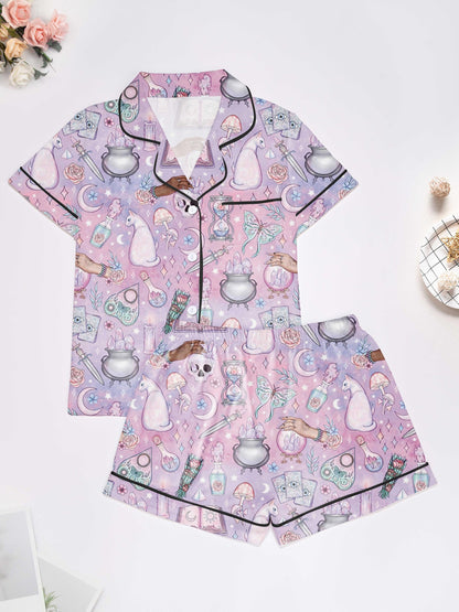Lavender short-sleeve women’s pajama set with tarot, crystals, crescent moons and cat motifs — button-up top and elastic waist shorts in 95% polyester 5% elastane