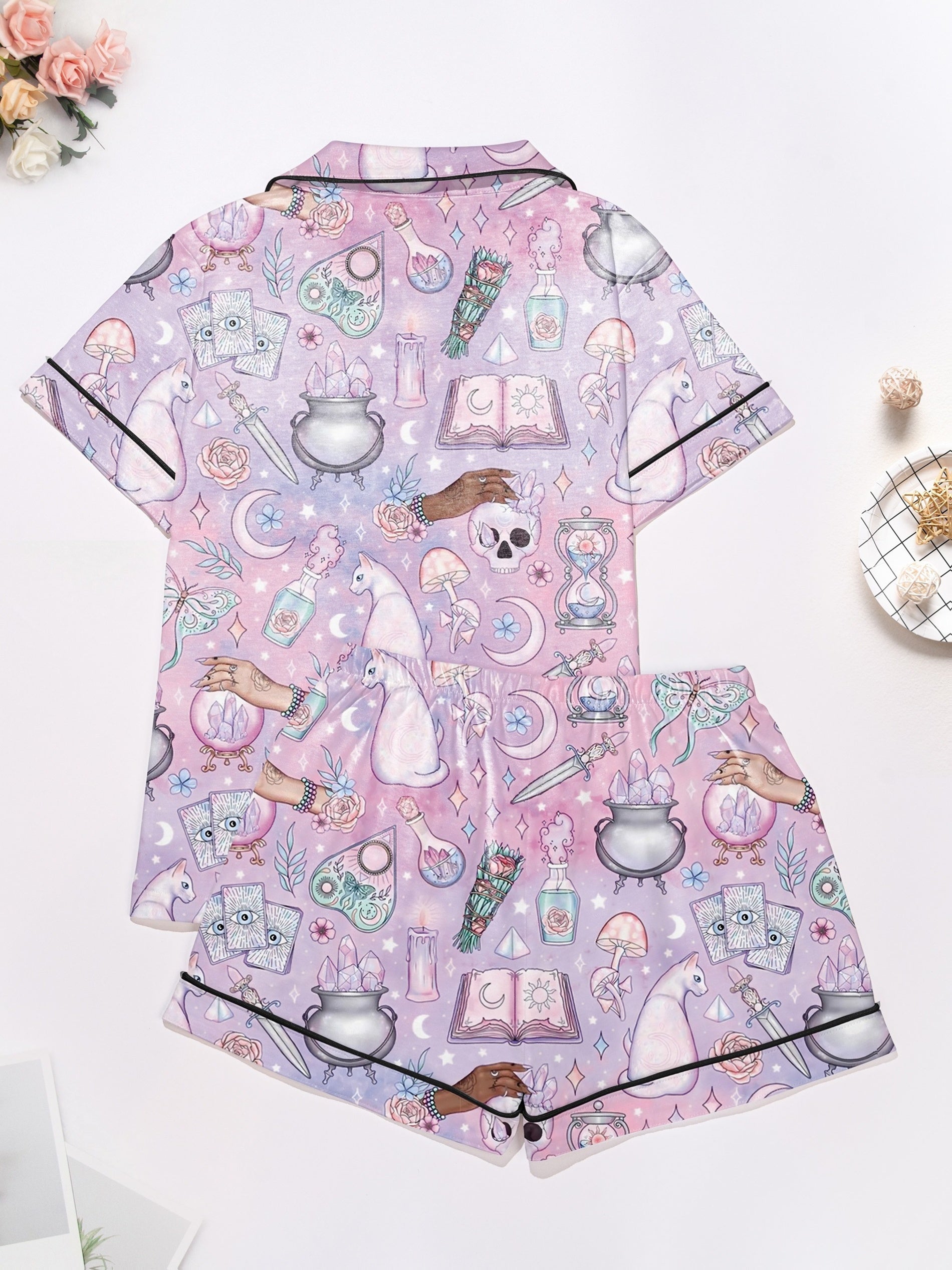Lavender short-sleeve women’s pajama set with tarot, crystals, crescent moons and cat motifs — button-up top and elastic waist shorts in 95% polyester 5% elastane