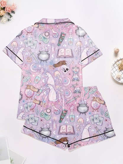 Lavender short-sleeve women’s pajama set with tarot, crystals, crescent moons and cat motifs — button-up top and elastic waist shorts in 95% polyester 5% elastane