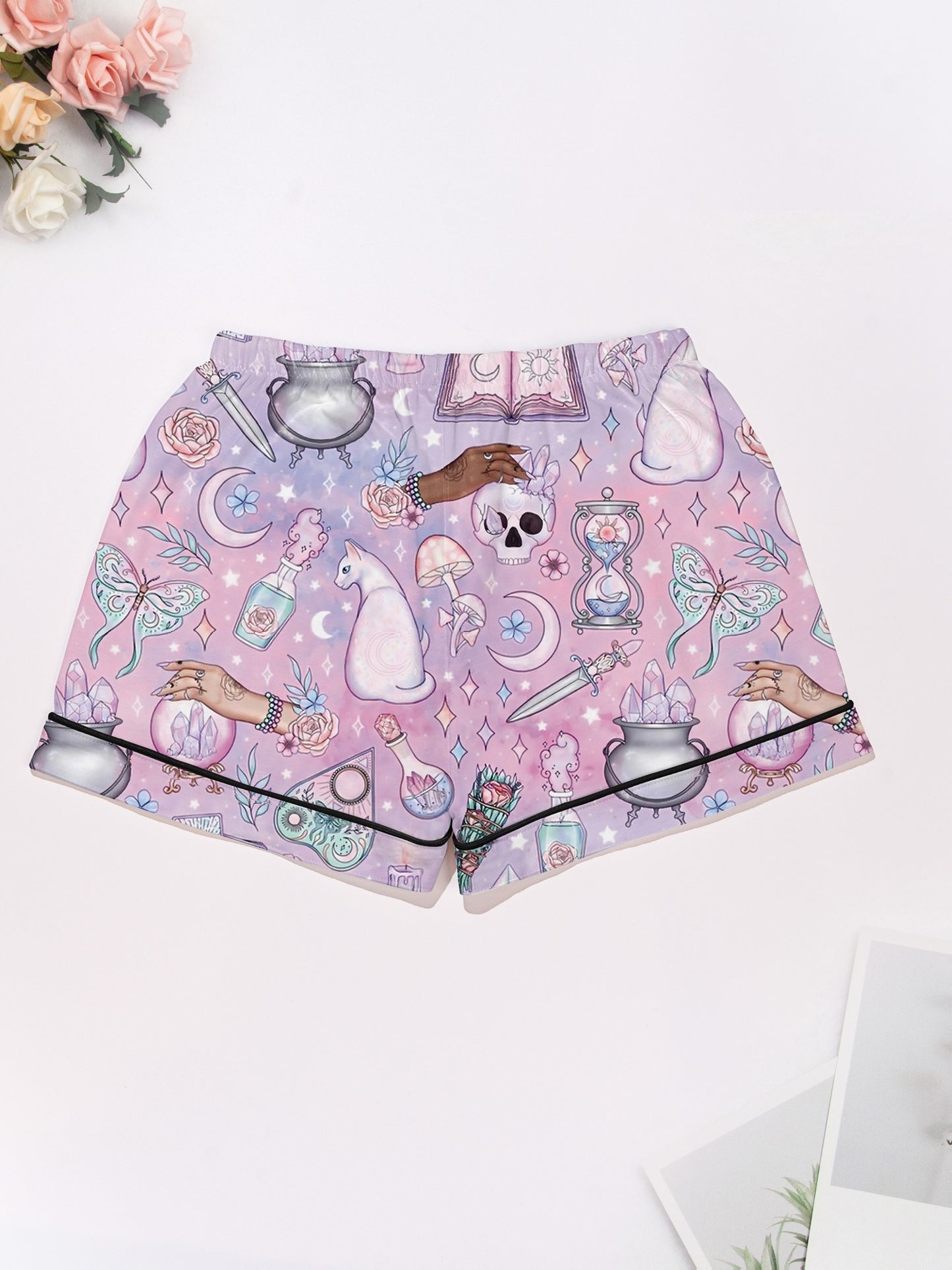 Lavender short-sleeve women’s pajama set with tarot, crystals, crescent moons and cat motifs — button-up top and elastic waist shorts in 95% polyester 5% elastane