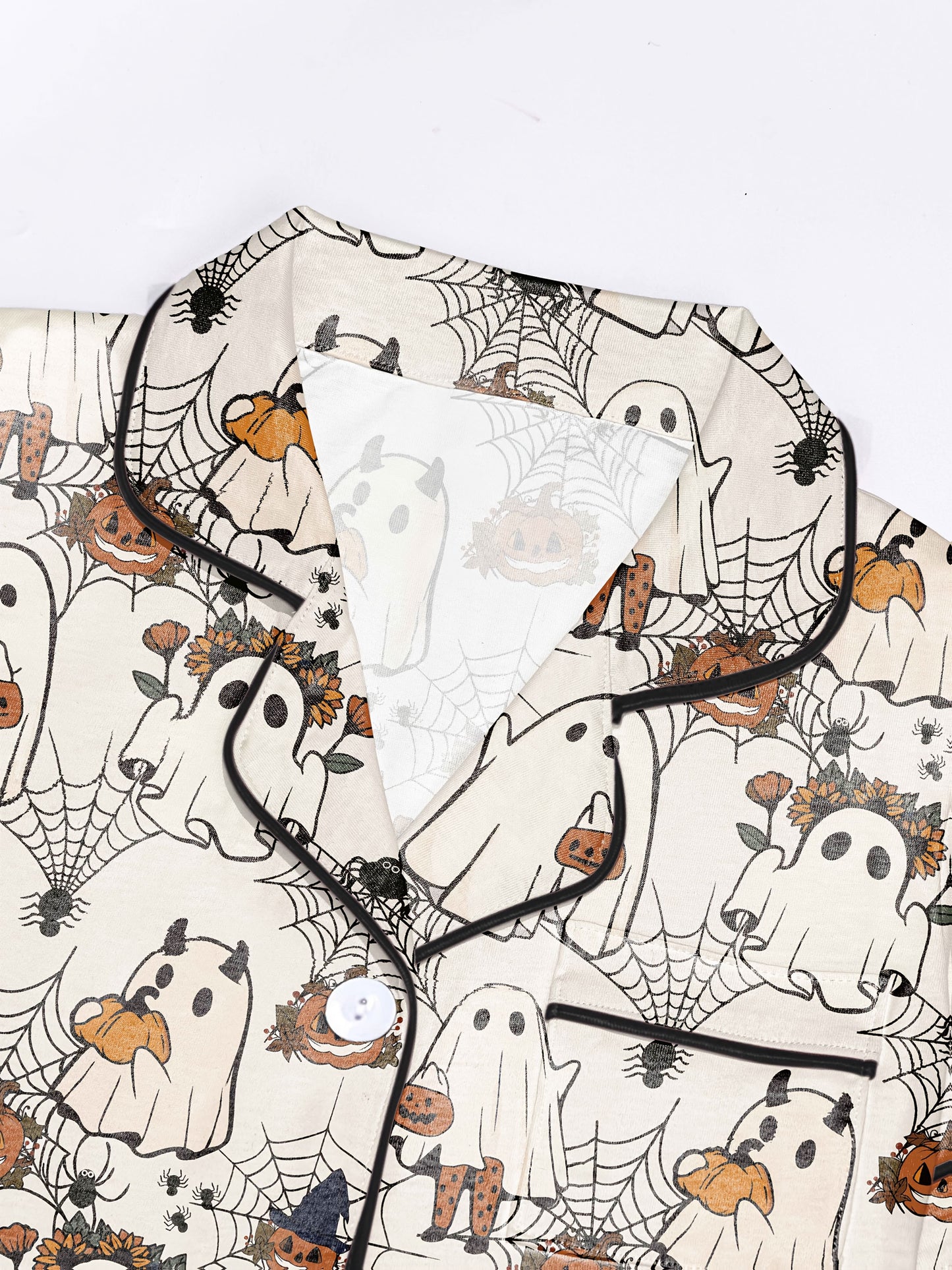 Light blush modal short‑sleeve pajama set with playful ghost, pumpkin and spiderweb print — button top and elastic waist shorts with black piping
