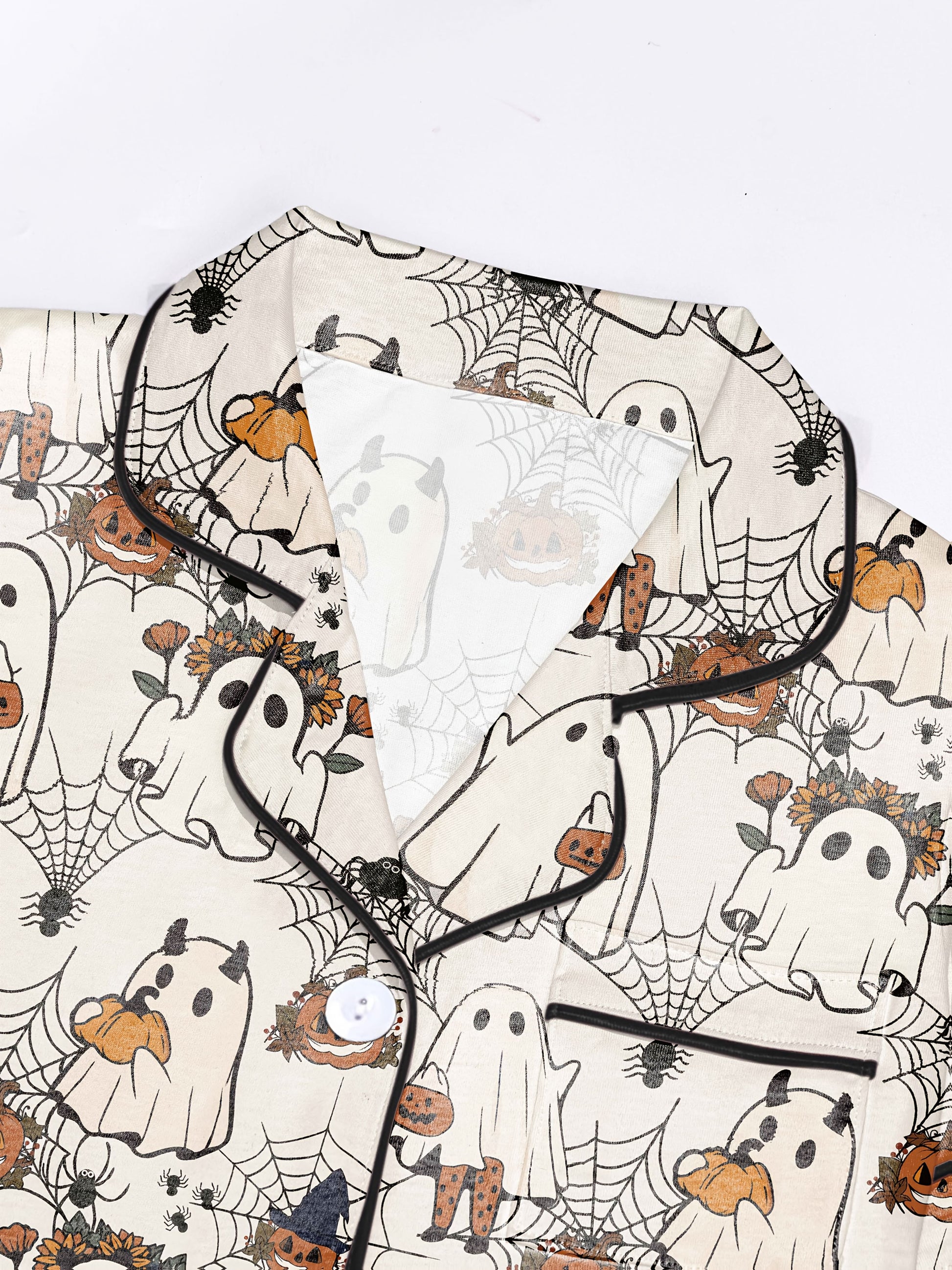 Light blush modal short‑sleeve pajama set with playful ghost, pumpkin and spiderweb print — button top and elastic waist shorts with black piping