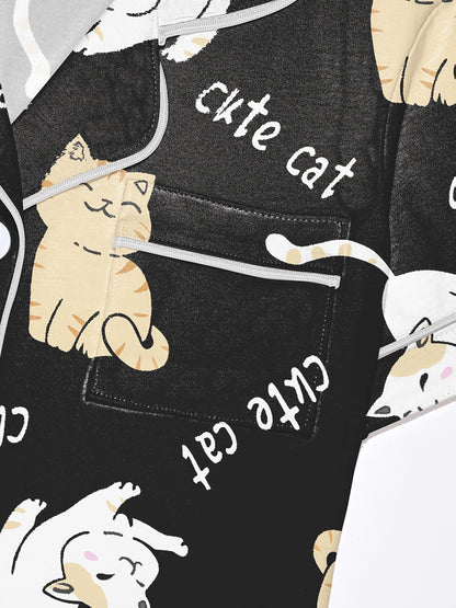 Black modal short‑sleeve pajama set with cream and tan cat print — button top with notch collar and elastic waist shorts with gray piping