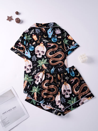 Black modal pajama set with skulls, snake and crystal print — short‑sleeve button top and elastic waist shorts with pale piping