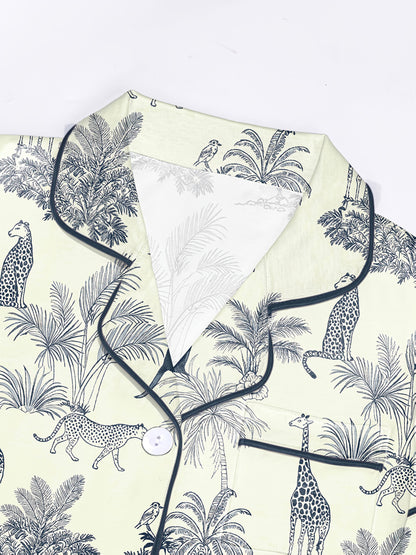 Cream modal short‑sleeve pajama set with navy botanical and safari animal print — button top with notch collar and elastic waist shorts with navy piping