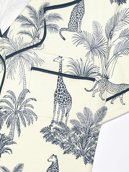 Cream modal short‑sleeve pajama set with navy botanical and safari animal print — button top with notch collar and elastic waist shorts with navy piping