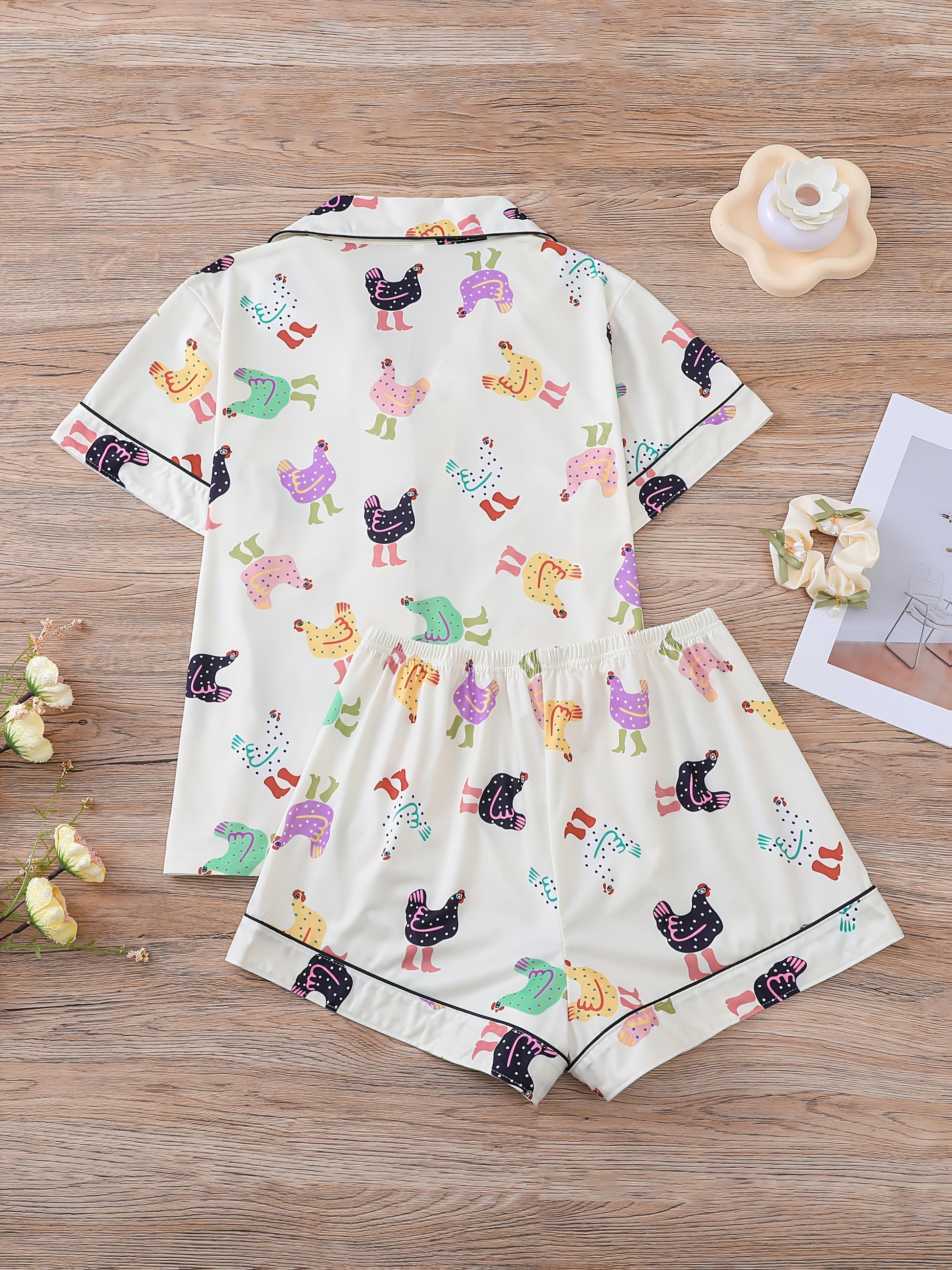 Cream satin-look short pajama set with pastel hen print — button-up short-sleeve top with chest pocket and elastic waist shorts, 95% Polyester/5% Elastane
