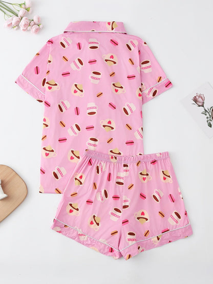 Pink satin-look short-sleeve pajama set with coffee cup and macaron print, piped trim, chest pocket and elastic waist shorts in 95% Polyester 5% Elastane — silky stretch travel-ready loungewear