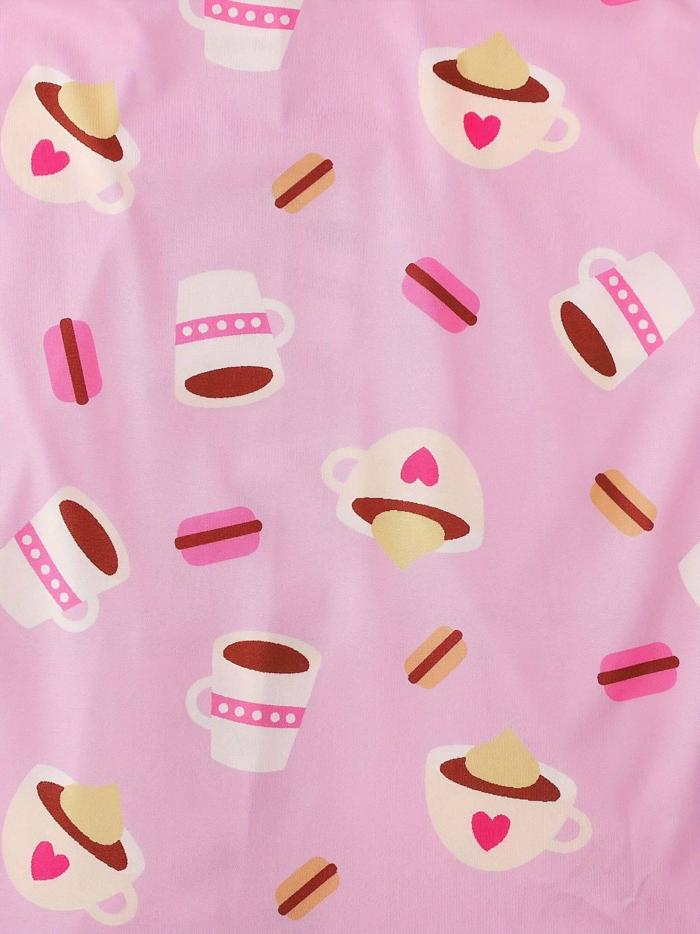 Pink satin-look short-sleeve pajama set with coffee cup and macaron print, piped trim, chest pocket and elastic waist shorts in 95% Polyester 5% Elastane — silky stretch travel-ready loungewear