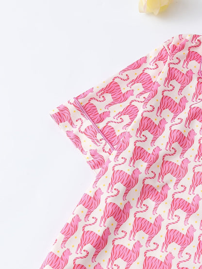 Pink satin-look short-sleeve pajama set with repeating zebra print, piped trim and elastic waist shorts in 95% Polyester 5% Elastane — silky stretch travel-ready loungewear