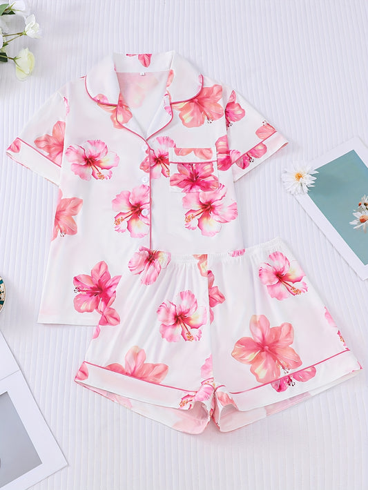 Pink satin-look short sleeve pajama set with watercolor floral print, piped trim, chest pocket and elastic waist shorts in 95% Polyester 5% Elastane — silky stretch loungewear