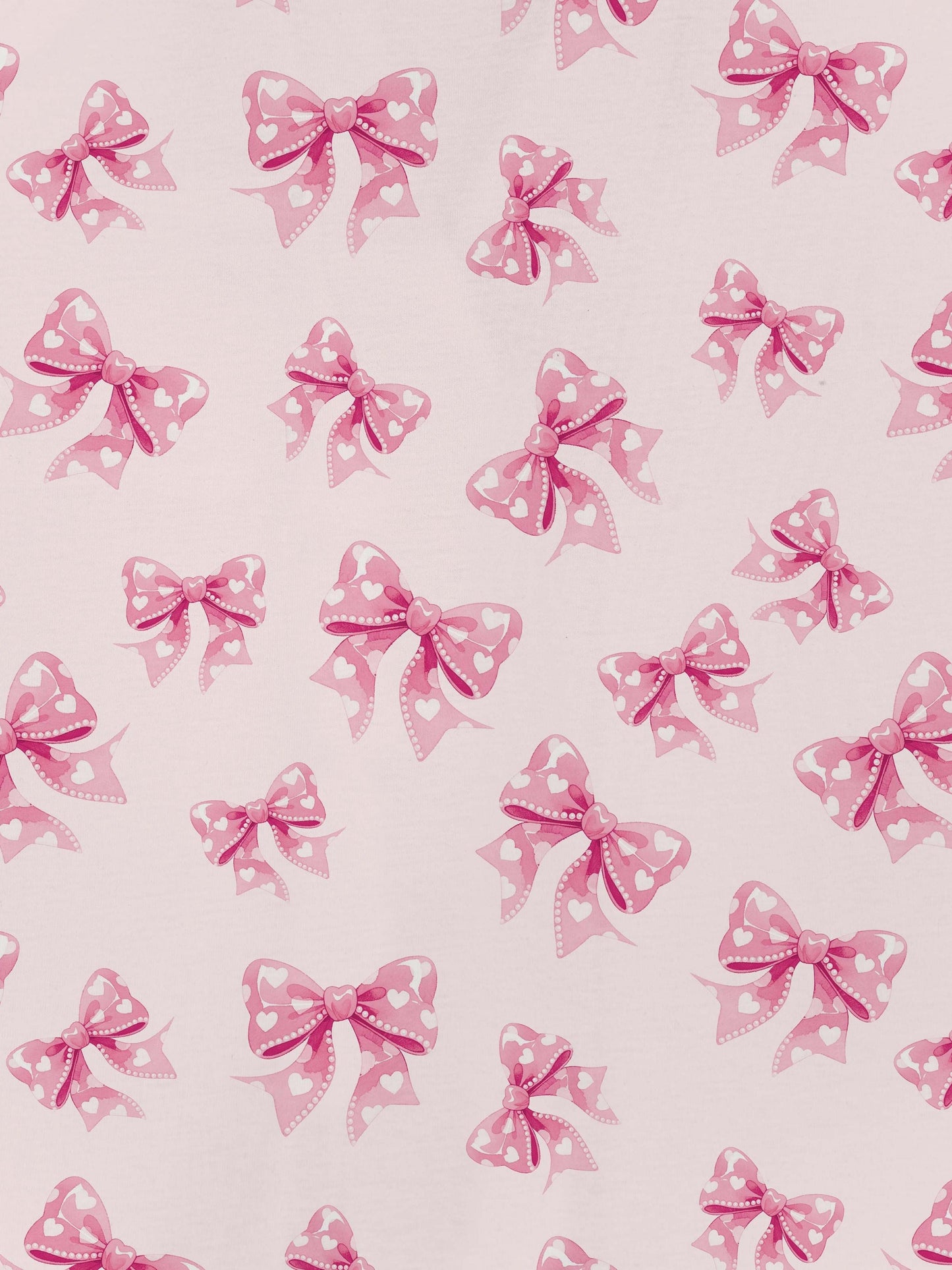 Pastel pink short-sleeve pajama set with heart-dotted bow print — button-up top and elastic waist shorts with pink piping