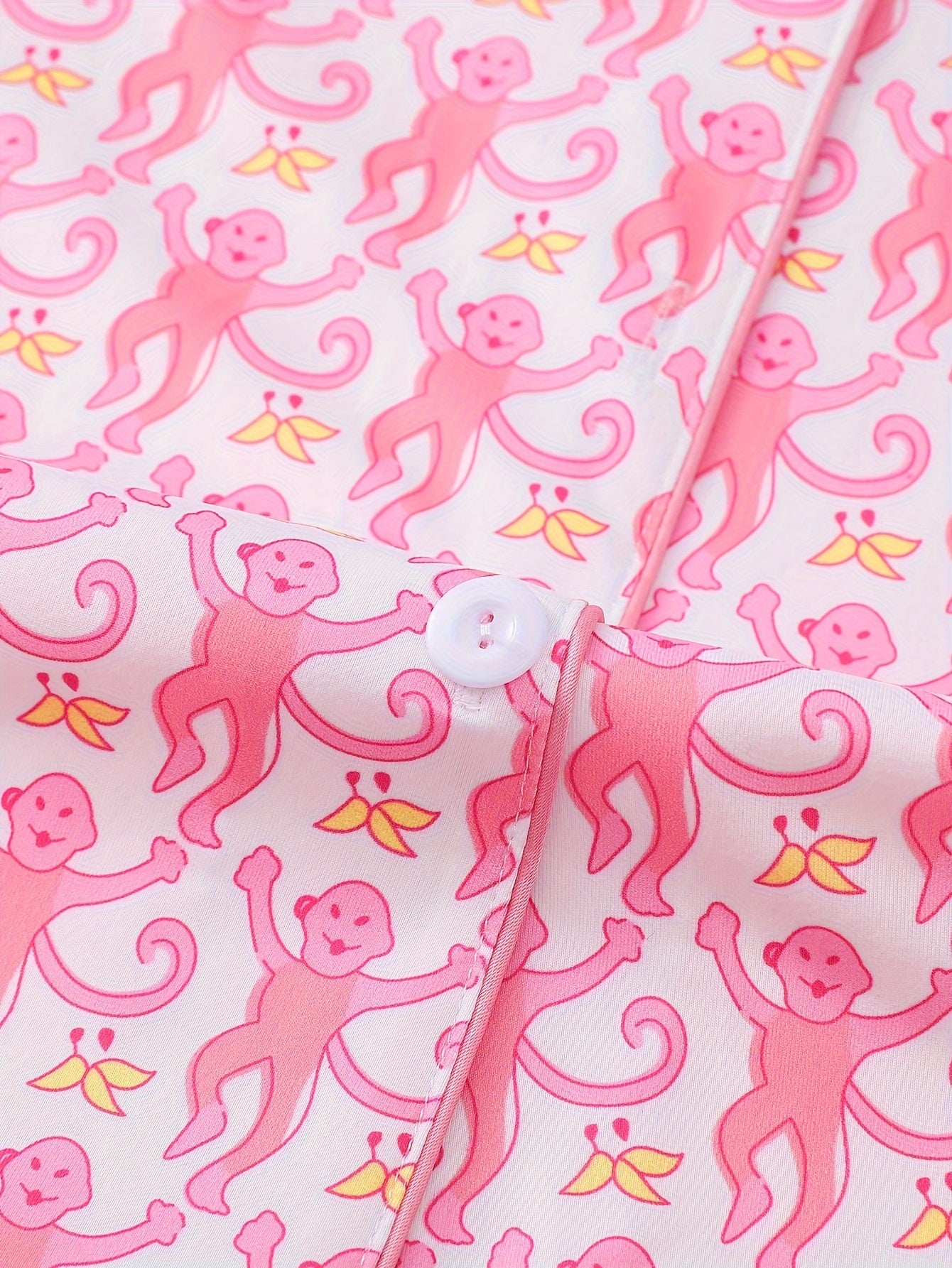 Blush modal short‑sleeve pajama set with all‑over pink monkey print — button top with notch collar and elastic waist shorts with piping