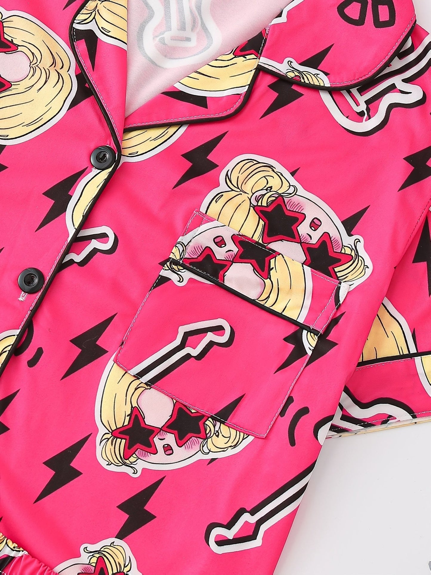 Bright pop-pink satin-look short-sleeve pajama set with guitar and star-sunglasses print, piped trim, chest pocket and elastic waist shorts in 95% Polyester 5% Elastane — silky stretch travel-ready loungewear