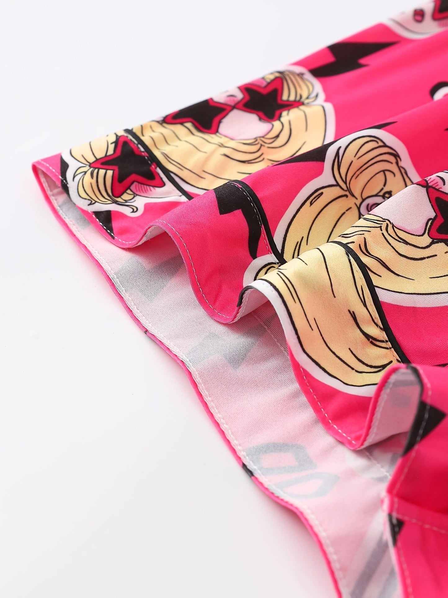 Bright pop-pink satin-look short-sleeve pajama set with guitar and star-sunglasses print, piped trim, chest pocket and elastic waist shorts in 95% Polyester 5% Elastane — silky stretch travel-ready loungewear