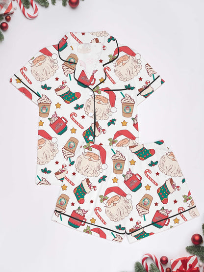 Cream modal pajama set with Santa faces and cocoa mugs print — short‑sleeve button top and elastic waist shorts with piping