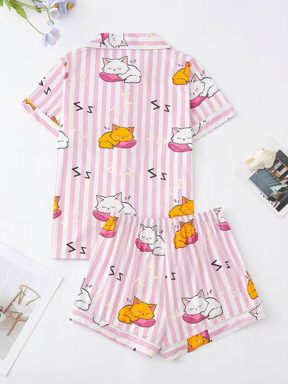Pink stripe satin-look short-sleeve pajama set with orange and white sleeping cat print, piped trim, chest pocket and elastic waist shorts in 95% Polyester 5% Elastane — silky stretch travel-ready loungewear