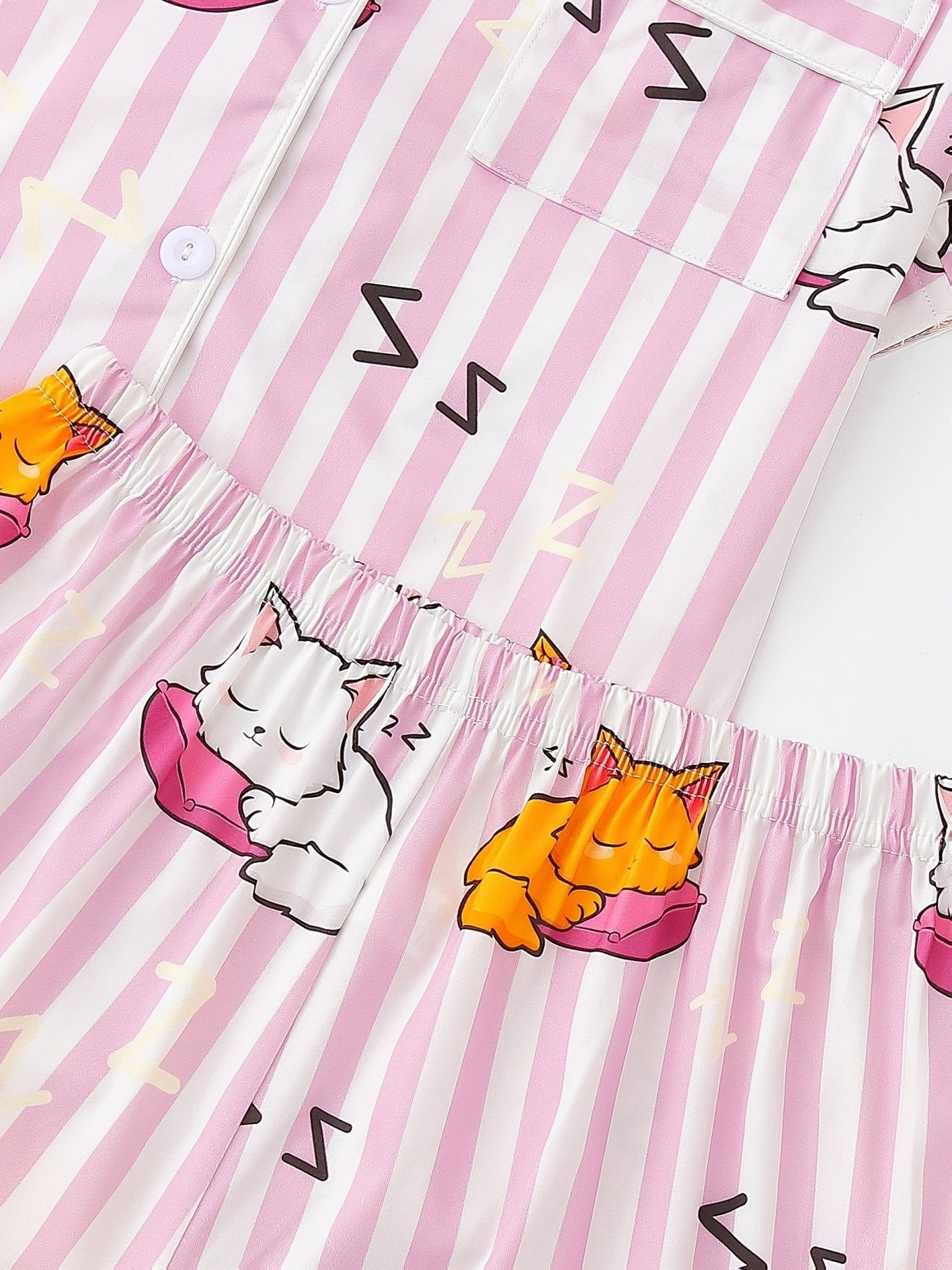 Pink stripe satin-look short-sleeve pajama set with orange and white sleeping cat print, piped trim, chest pocket and elastic waist shorts in 95% Polyester 5% Elastane — silky stretch travel-ready loungewear