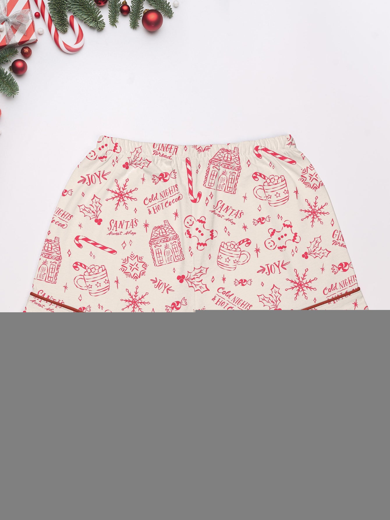 Cream short-sleeve women’s pajama set with red holiday sketch print of gingerbread houses, candy canes and cocoa mugs — short top and elastic waist shorts in 95% polyester 5% elastane