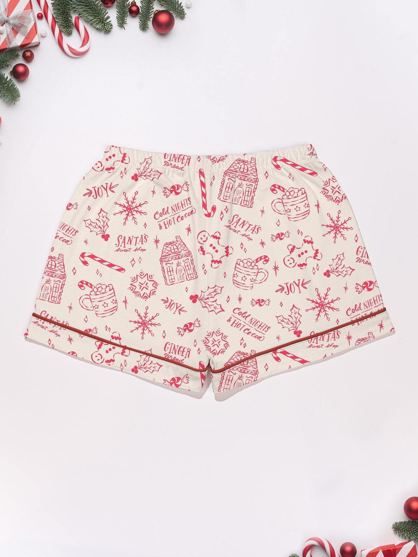 Cream short-sleeve women’s pajama set with red holiday sketch print of gingerbread houses, candy canes and cocoa mugs — short top and elastic waist shorts in 95% polyester 5% elastane