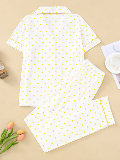 Cream satin-look pajama set with small yellow heart print — short-sleeve button-up top with chest pocket and elastic waist pants, 95% Polyester/5% Elastane