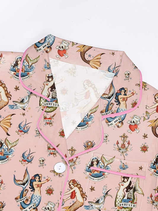 Blush modal short‑sleeve pajama set with vintage mermaid tattoo print — button top with notch collar and elastic waist shorts with pink piping