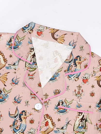 Blush modal short‑sleeve pajama set with vintage mermaid tattoo print — button top with notch collar and elastic waist shorts with pink piping