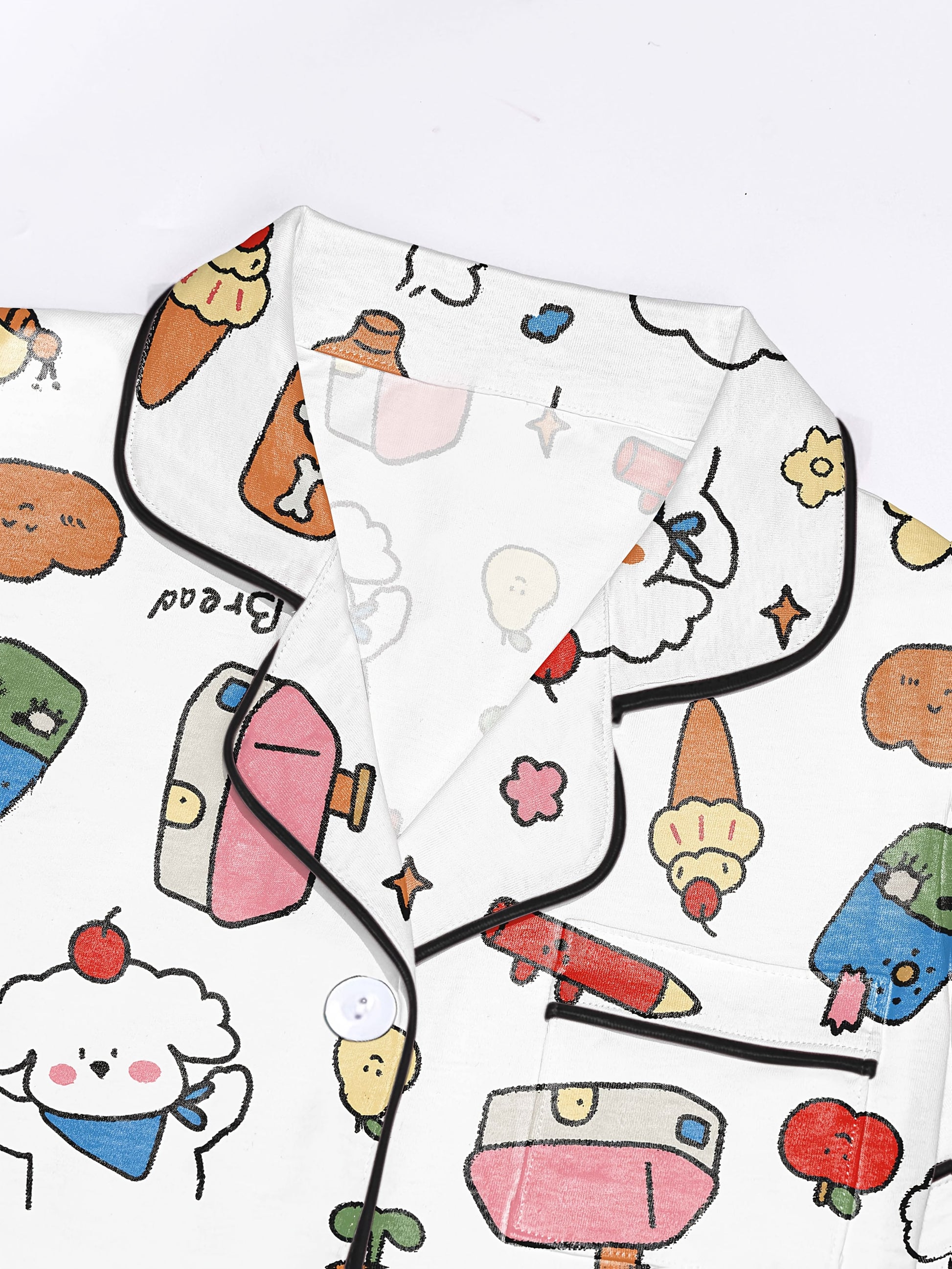 Ivory modal short‑sleeve pajama set with colorful doodle print — button top with notch collar and elastic waist shorts with black piping