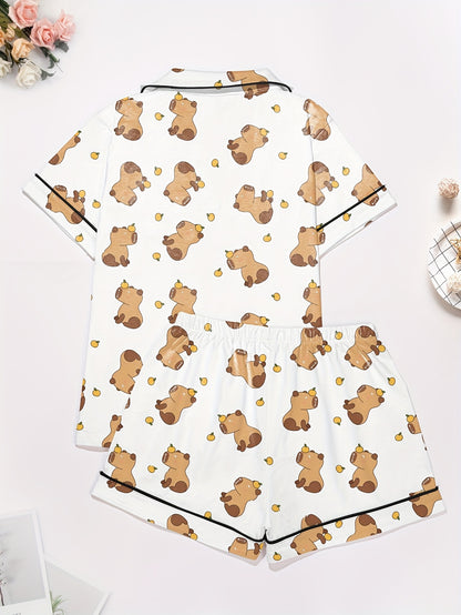 White short-sleeve pajama set with brown bear and yellow pear print — button-up top and elastic waist shorts with black piping