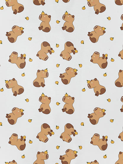 White short-sleeve pajama set with brown bear and yellow pear print — button-up top and elastic waist shorts with black piping